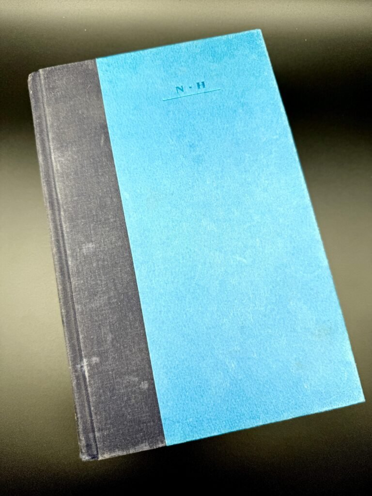 JFK: Reckless Youth. Book in the center of the screen with a black background behind it.